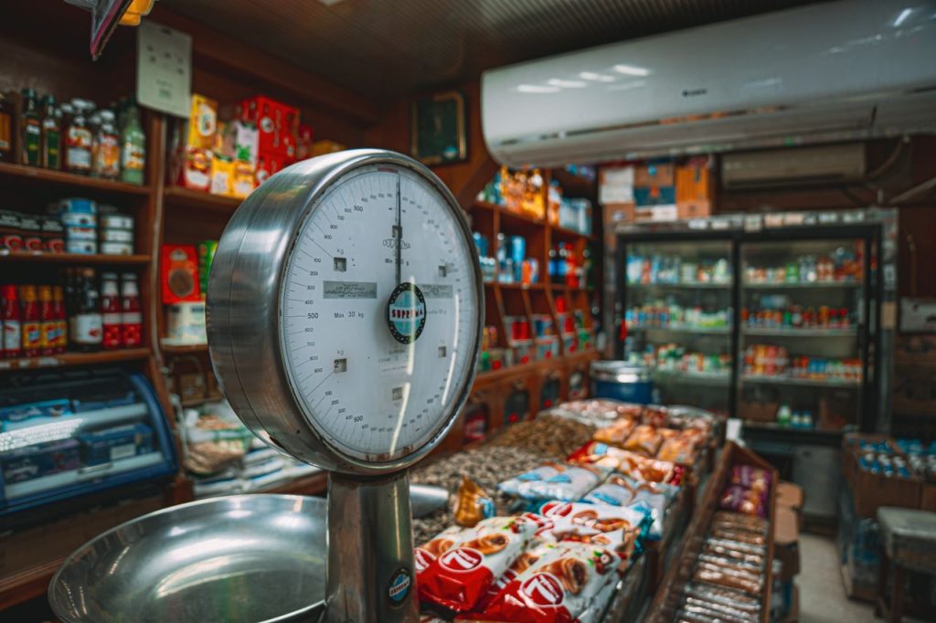 A cozy shop interior featuring a vintage weighing scale and a variety of products on display.